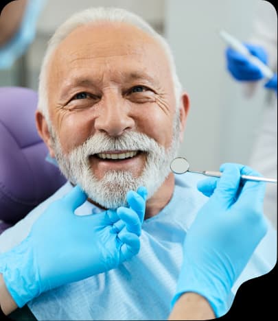 Dentist checking a smiling patient's teeth during a routine checkup